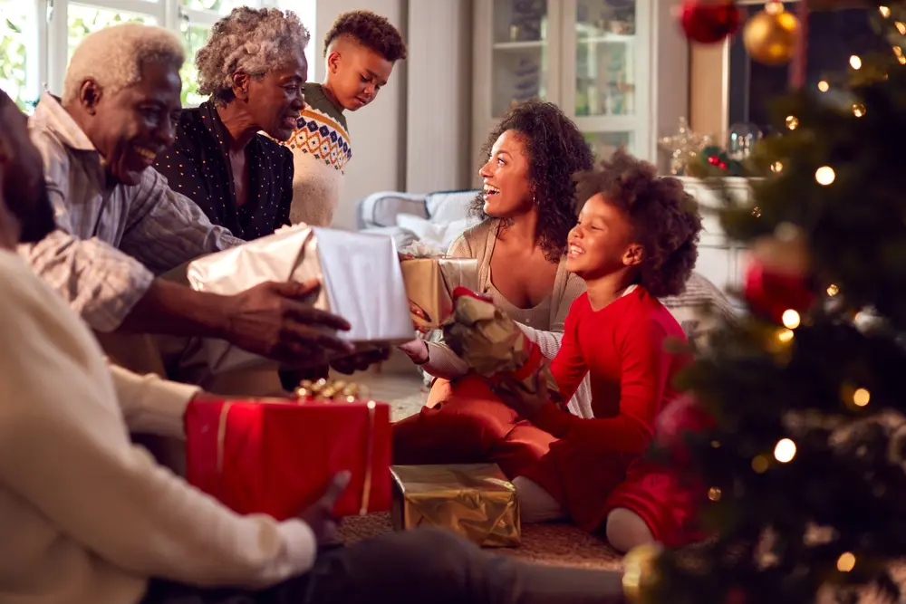 A family exchanging gifts in the living room.