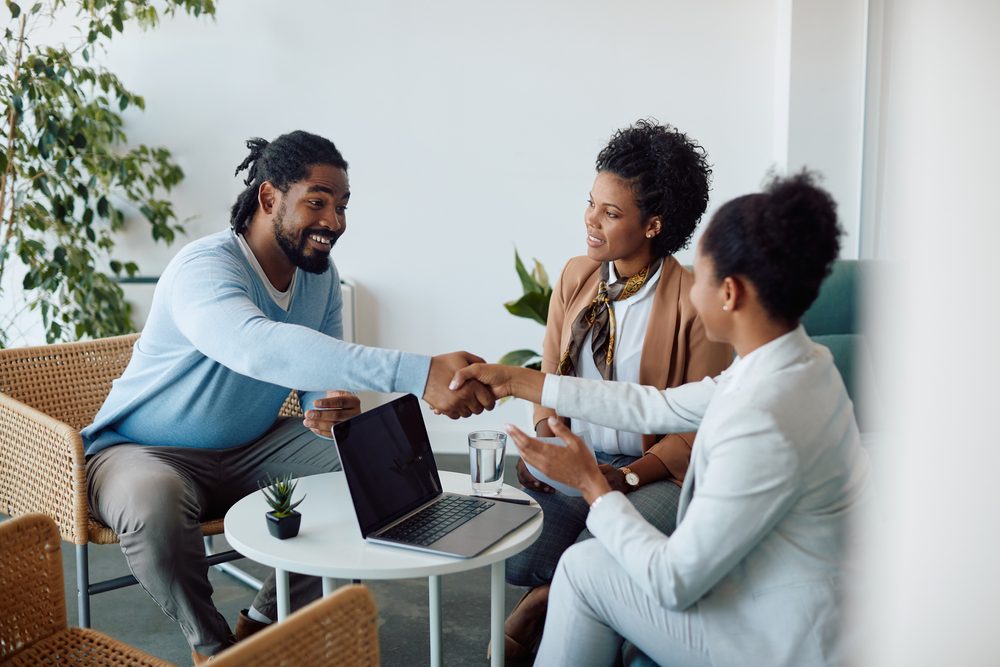 A couple talking with their loan officer.