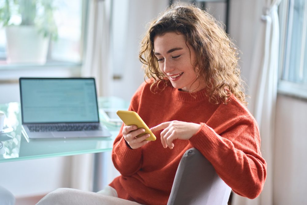 A woman is looking at her phone.