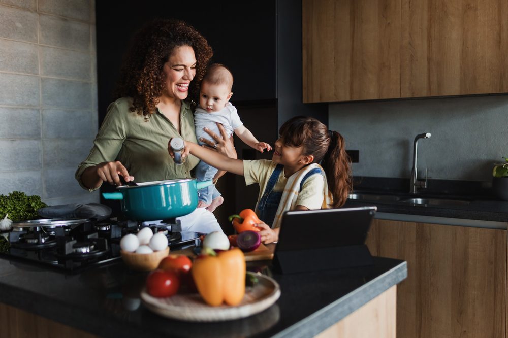 A mother preparing dinner with her children.